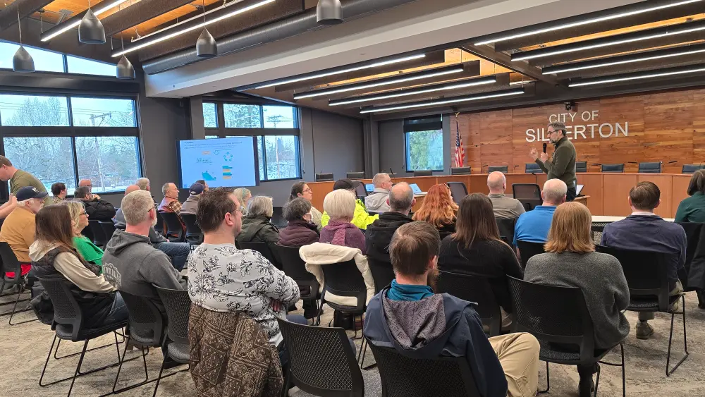 A large group of local Willamette Valley area business owners in SIlverton at the City of Silverton building are discussing the Chamber of Commerce, all of the benefits of membership, tips for new businesses, women owned business support, chamber of commerce near me, advantages of networking in business, and business advocacy