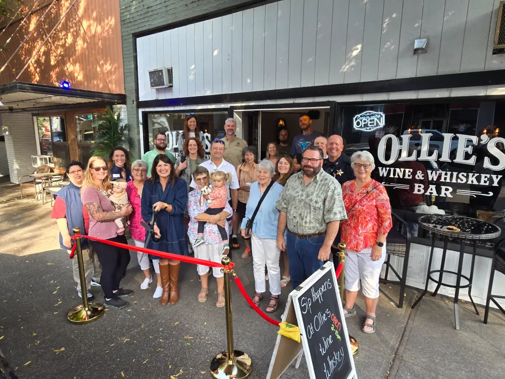 Ribbon cutting at Ollie's Wine & Whiskey Bark a local business in Silverton with a group of community members, Members of Silverton's Chamber of Commerce stand with employees at Ollie's showing advantages of networking in business, business network support for small business, ways to support small businesses, benefits of being a chamber of commerce member, and community support.
